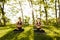 Photo of two ladies in black sporty tops and leggings sitting in lotus poses and meditating together