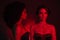 Photo of two ladies over red mist neon background having occult ritual celebrate halloween holiday private event