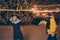 Photo of two people guy lady playing lights night park x-mas night throwing snowballs having fun free time wear warm