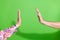 Photo of two people hands palms reaching touch each other giving high five  green color background