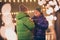 Photo of two people retired couple hold mugs drink hot winter boiled cocktail carefree communication wear mittens coat