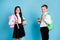 Photo of two small girl boy schoolchildren brother sister classmates hold pile books library study year beginning wear