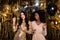 Photo of two stunning girls dance prom balloons funky wear dress  on shine tinsel background