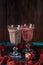 Photo of two wineglasses with smoothies on table