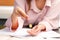 Photo of two woman hands counting coins to make invoice payments having documents on the table, paying bills problem