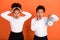 Photo of two young afro school kids surprised omg missed punctuality time study isolated over orange color background