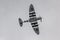 Photo of the underside of a spitfire as it flies above the skies of the UK