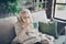 Photo of unhappy blond aged granny caught cold sneezing napkin drink hot tea beverage sitting sofa divan covered plaid