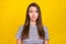 Photo of unhappy doubtful upset young woman scared stressed face bad mood isolated on yellow color background