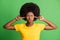 Photo of unhappy irritated dark skin woman cover ears fingers avoid isolated on green color background