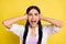 Photo of unhappy stressed young woman cover hands ears loud noise enough isolated on yellow color background