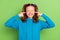 Photo of unhappy upset small girl cover ears fingers enough avoid loud noise isolated on green color background