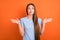 Photo of unsure brown hairdo young lady shrug shoulders look empty space wear blue t-shirt isolated on vivid orange