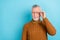 Photo of unsure suspicious retired man wear brown sweater arm spectacles looking empty space isolated blue color