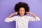 Photo of upset afro american girl close ears fingers loud noise wear white dotted jumper isolated on violet color