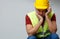 Photo of upset builder male in yellow helmet with walkie-talkie