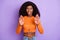 Photo of upset strict dark skin lady wear orange shirt showing palms isolated violet color background