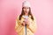 Photo of upset unhappy girl hold look phone negative comment dislike isolated on shine pastel pink color background