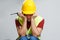 Photo of upset worker in yellow helmet with walkie talkie.