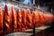 Photo of a variety of meats hanging on a line in a market or butcher shop. Industrial smoking of sausages and meat products. Farm