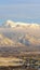 Photo Vertical Amazing winter view of Mount Timpanogos against sky with snowy peak above clouds