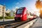 Photo of a vibrant red and white train or tram speeding down train tracks in the city