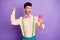 Photo of victorious happy amazed ma wear green suspenders raise fist hold phone isolated on violet color background