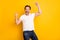 Photo of victorious happy cheerful man raise hands win lucky isolated on shine yellow color background