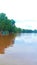 Photo of the view where fishing boats rest on the bank of a river with murky brown water