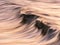 Photo of a wave at sunset with panning technique