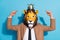 Photo of weird eccentric guy in lion mask festive event character point hand gold tiara  over blue color