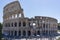 Photo of the West side of the Colosseum with tourists in the foreground seen from Tempio di Venere e Roma in Rome