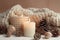 photo of winter composition lighted candles white knitted sweater pine cones and anise on a pastel backgroun