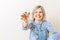 Photo of woman with keys from apartment against blank wall