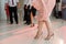 photo of woman legs in stylish high hell shoes on floor dancing at a wedding party