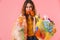 Photo of woman with rubber glove in her moth holding plastic waste