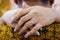 A photo of a woman\'s hands wrapped in the neck of the guy featuring her engagement ring