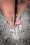 Photo of a Women`s feet and legs with colored nail polish on toes, Cape Town