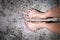 Photo of a Women`s feet and legs with colored nail polish on toes, Cape Town