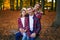 photo of a wonderful family in the autumn forest on a bench