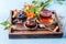 Photo of wooden tray with cupcake with cream