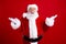Photo of worried nervous uncertain unsure pensioner santa claus raising hands no answer isolated on red color background