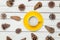 Photo of yellow cup of coffee near dried beautiful cones on the