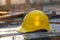 Photo Yellow hard hat safety helmet on construction site, essential gear
