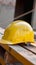 Photo Yellow hard hat safety helmet on construction site, essential gear