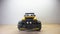 Photo of a yellow radio controlled offroad sports car racing toy car  on a wooden base