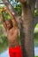 Photo of a young African American fitness model stretching in the park. Man posing shirtless showing muscles