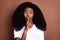 Photo of young afro girl cover lips fingers shh shut up keep secret conspiracy isolated over brown color background