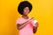 Photo of young afro girl happy positive smile hungry lick tongue lips food eat open jar isolated over yellow color