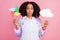 Photo of young afro girl plump lips amazed hold poster banner playful isolated over pink color background